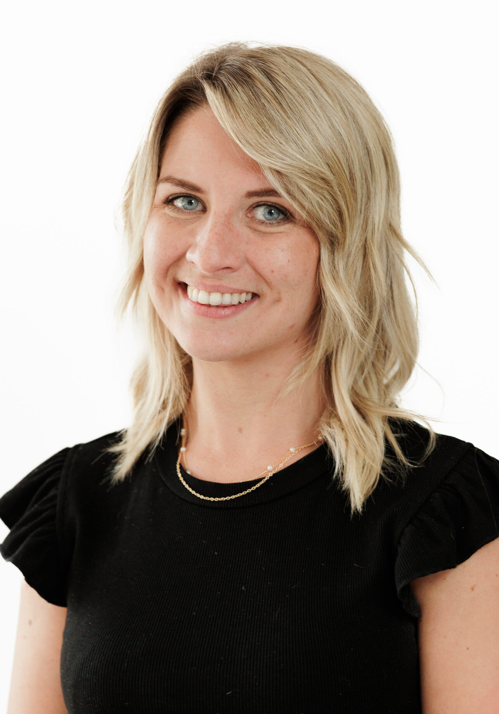 A smiling woman, representing a member of the SmartAssessor team.