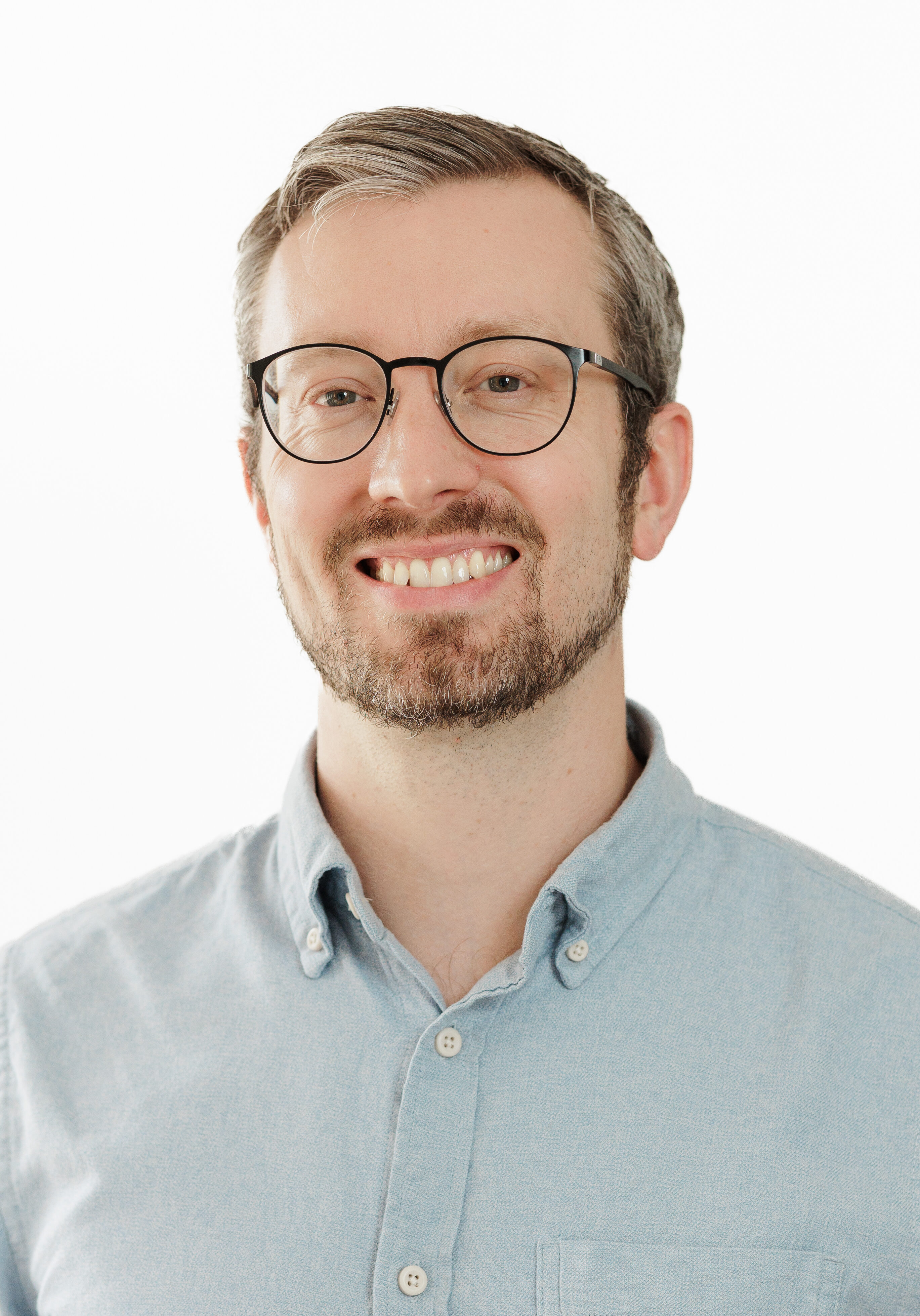 A diverse group of professionals in a modern office setting, representing the SmartAssessor team.