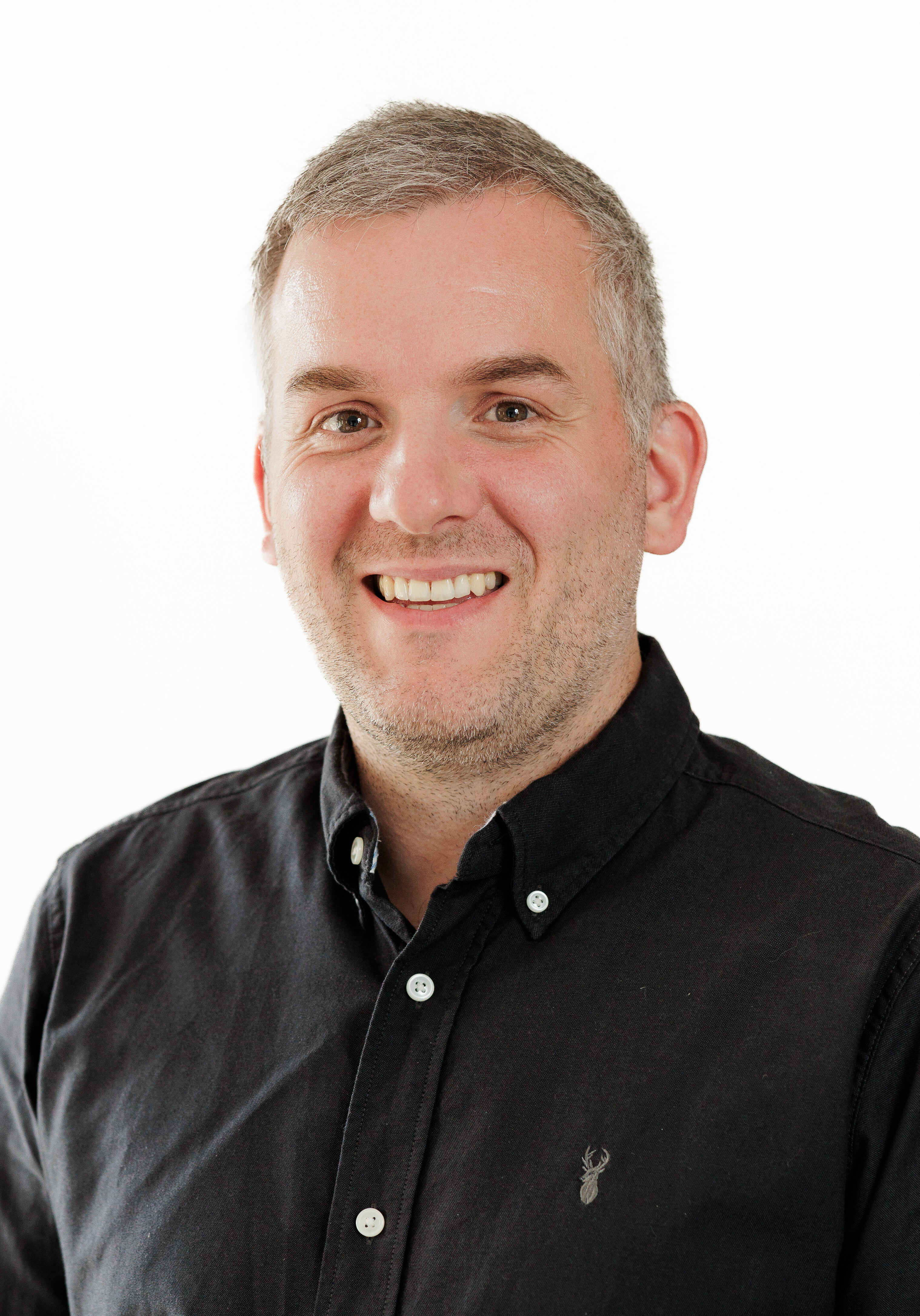 A diverse group of professionals in a modern office setting, representing the SmartAssessor team.